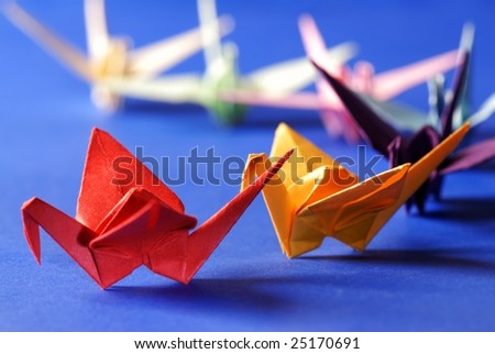 origami birds over blue backgrounds