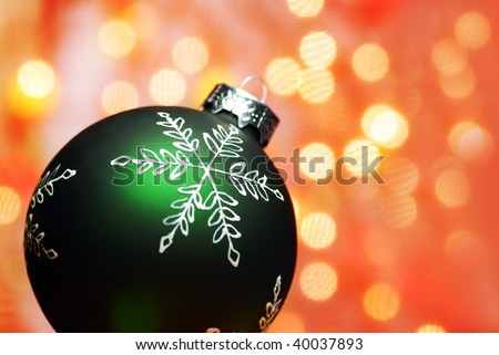 Christmas Decoration--Closeup of green christmas ball with abstract light background.