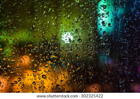 Drops of night rain on window, abstract background