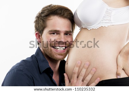 Happy father on the belly of his pregnant wife