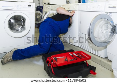 echnician repairing a washing machine