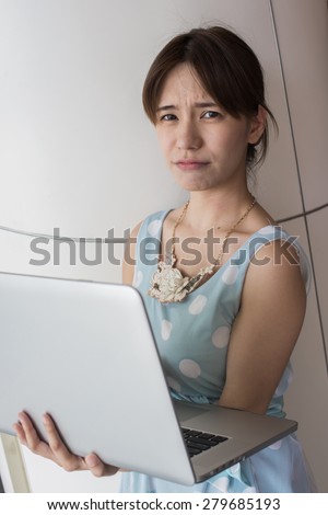 Unhappy woman because she is under stress and frustrated in her job. Portrait of asian.