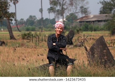 Agriculturist male with loincloth wrapped over the head sitting relax and cross one's arm at the nature. Stock fotó © 