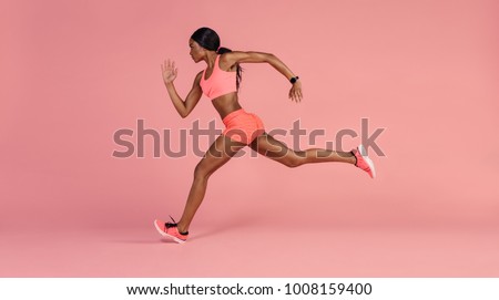 Image, Stock Photo Young woman in sportswear exercising on a river promenade