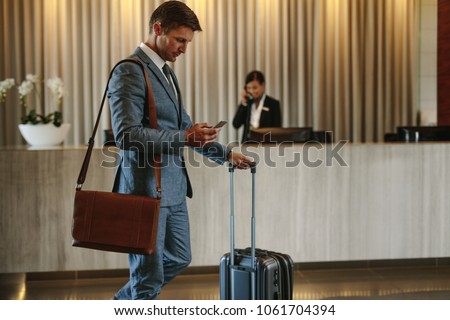 Similar – Image, Stock Photo Man using his smartphone sitting on a ledge outside