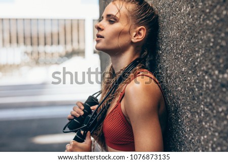 Similar – Image, Stock Photo Sportswoman leaning on wall on street and looking at camera