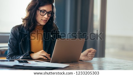 Photo of Asian woman working laptop. Business woman busy working on laptop computer at office.