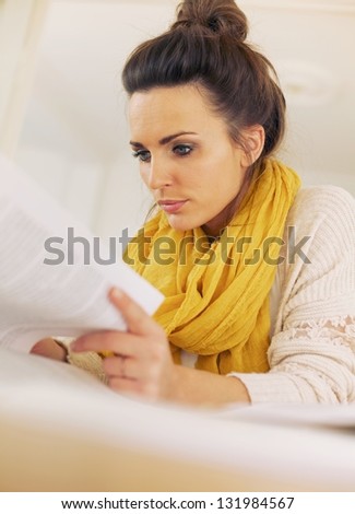 Closeup of a beautiful young woman busy reading her textbook for the exam