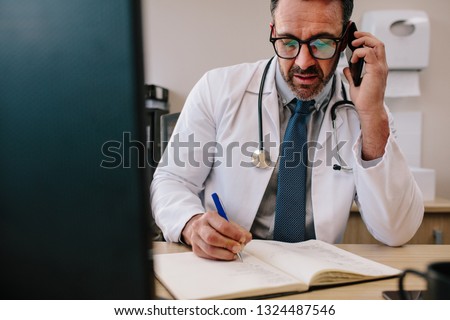 Similar – Image, Stock Photo Doctor making a phone call. Hospital staff working at night duty. Woman wearing uniform, cap and face mask to prevent virus infection