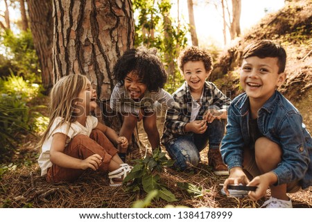 Image, Stock Photo Ethnic child playing with toy windmill in field