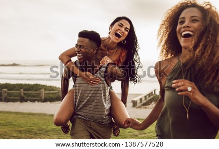 Similar – Foto Bild Fröhlich diverse Freundinnen lachen und nehmen Selfie auf Rasen im Park liegen