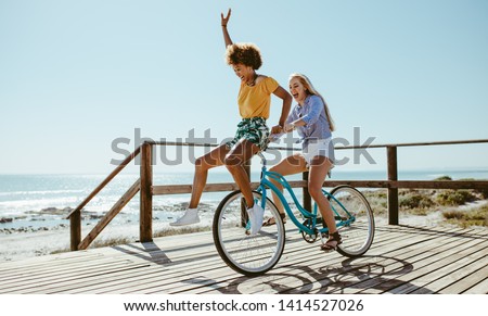 Similar – Image, Stock Photo Ethnic woman with bicycle on street