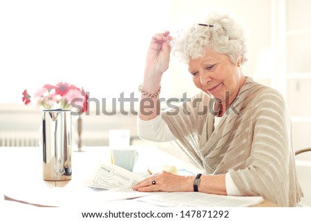 Grandma at home busy reading something