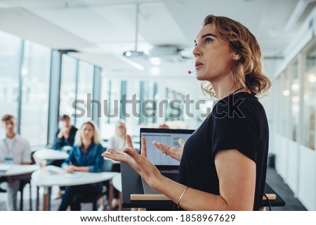 Businesswoman delivering a presentation at a conference. Female entrepreneur sharing new business ideas in a conference.