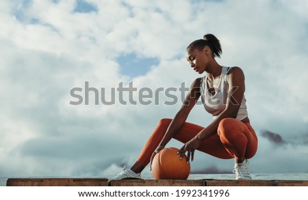 Similar – Image, Stock Photo Tired sportswoman with basketball ball resting on court