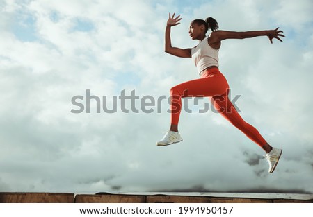 Similar – Image, Stock Photo Sportswoman jumping on terrace during training