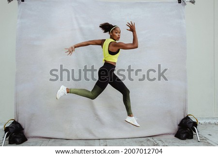 Similar – Image, Stock Photo Sportswoman jumping on terrace during training