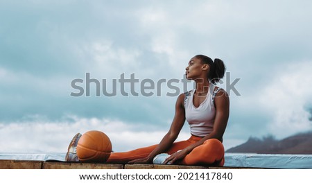 Similar – Image, Stock Photo Tired sportswoman with basketball ball resting on court