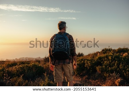 Similar – Image, Stock Photo Anonymous man enjoying mountain landscape and lake