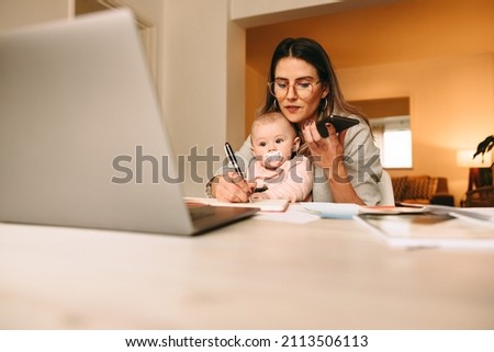 Similar – Image, Stock Photo Businesswoman making notes during workday at home