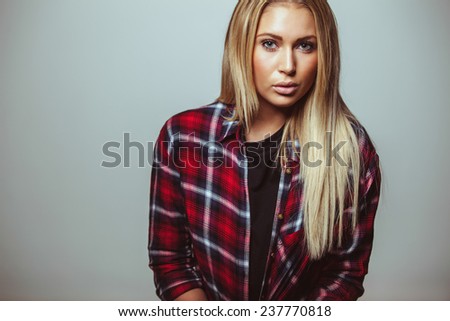 Cropped image of attractive young woman looking at camera. Female model in casual outfit.