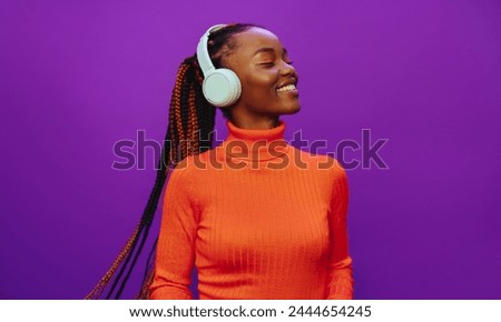 Similar – Image, Stock Photo Happy young woman listening music in headphones in the city