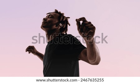 Similar – Image, Stock Photo Man with earbuds using tablet and laptop at table