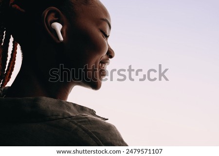 Image, Stock Photo Young woman listening to music from vinyl record player. Playing music on turntable player. Female enjoying music from old record collection at home