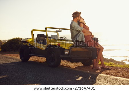 Young man and young woman on road trip on a beautiful summer\'s day.