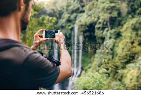 Similar – Man photographing landscape from observation deck