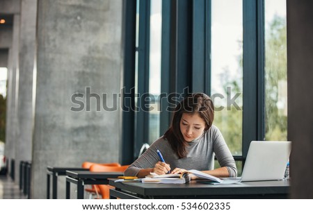 Similar – Image, Stock Photo A young female student is sitting on the floor and reading a book, enjoying reading on a weekend or preparing for classes at school or university. Back to school, preparing for classes, free time