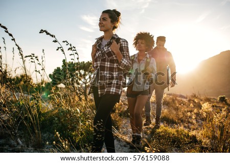 Similar – Foto Bild Person, die auf einer Landstraße zwischen Meer und Feld geht