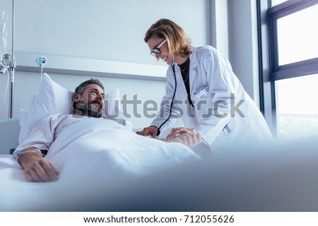 Similar – Image, Stock Photo Male doctor examining patient in medical room