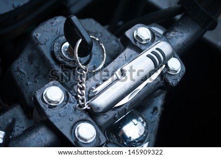 motor cycle keys installed into the ignition lock