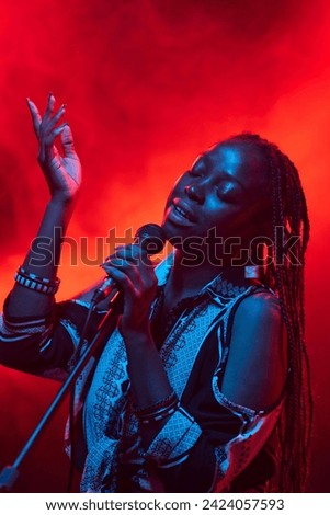 Similar – Image, Stock Photo Creative woman singing and playing guitar on stage