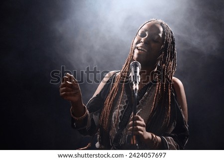 Similar – Image, Stock Photo Creative woman singing and playing guitar on stage