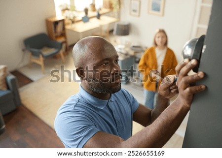 Similar – Image, Stock Photo Ethnic man smoking in studio with neon lights