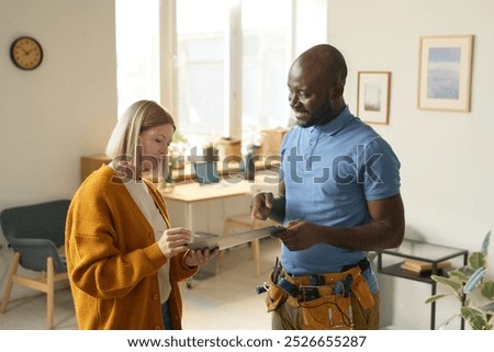 Similar – Image, Stock Photo Plumber signs a contract for the services in the kitchen