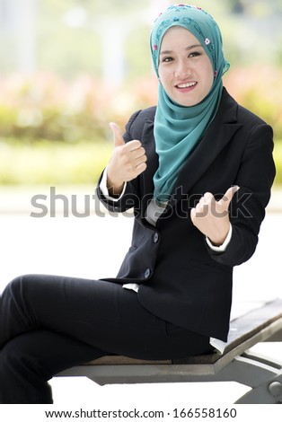 Young business woman happy and thumb up