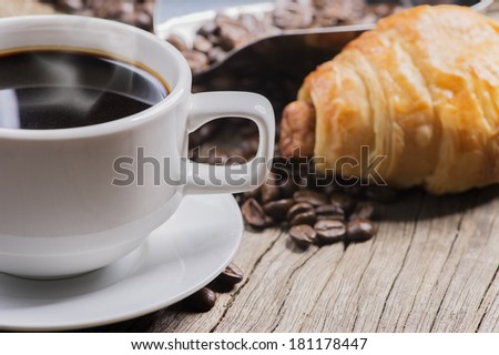 hot coffee and bread on wooden background