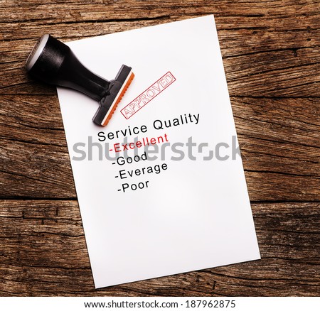 Excellent evaluation of Service Quality on paper over wooden background