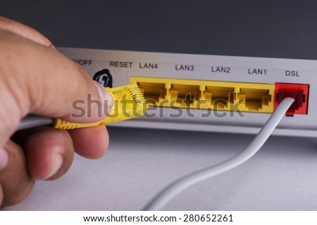 Close up hand connecting networking cable