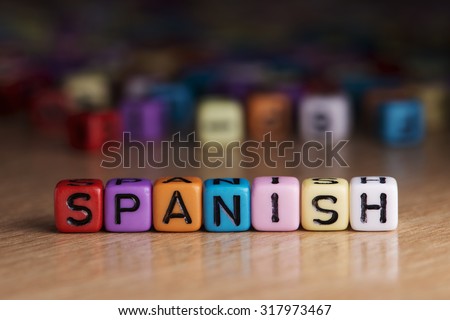 spanish words with dices on wooden table