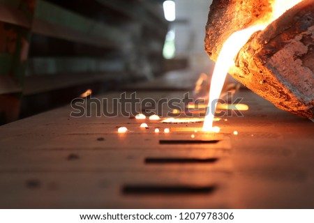 Light from high temperature Iron molten metal pouring in green sand mold ;Foundry process to manufacture cast product for automotive and electrical; industrial engineering metallurgy background ,  商業照片 © 