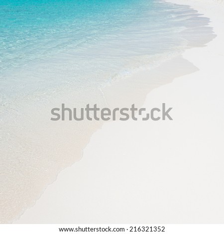Ocean waves rolled on a white sandy beach. Symbol advertising holidays, relaxation