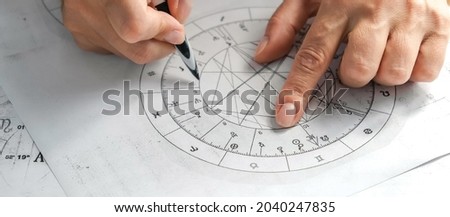 Astrology. Astrologer calculates a natal chart and makes a forecast of fate. Astrological forecast, mysticism, science. Astrological background.