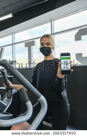 Fitness,sports.fit,Girl in mask fitness gym  opening lockdown covid passport,QR cod Wellness, health care,generation z sports recreation concept online fitness apps. workout,training,Fit wellness