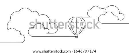 Hot air balloon floating in the sky among clouds in continuous line art drawing style. Minimalist black linear design isolated on white background. Vector illustration