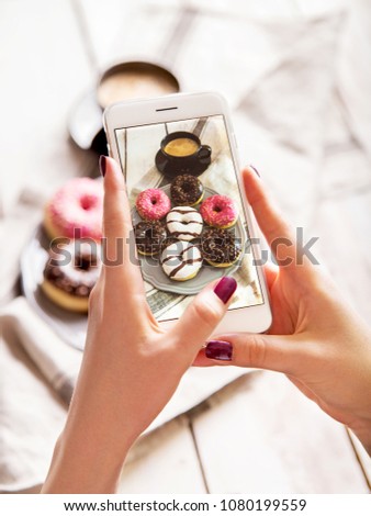 Similar – Image, Stock Photo Taking photos of donuts with the smartphone. Photographing food top view.