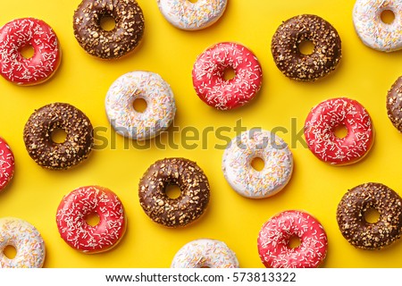 Similar – Image, Stock Photo Chocolate glazed donuts pattern. One doughnut with a missing bite